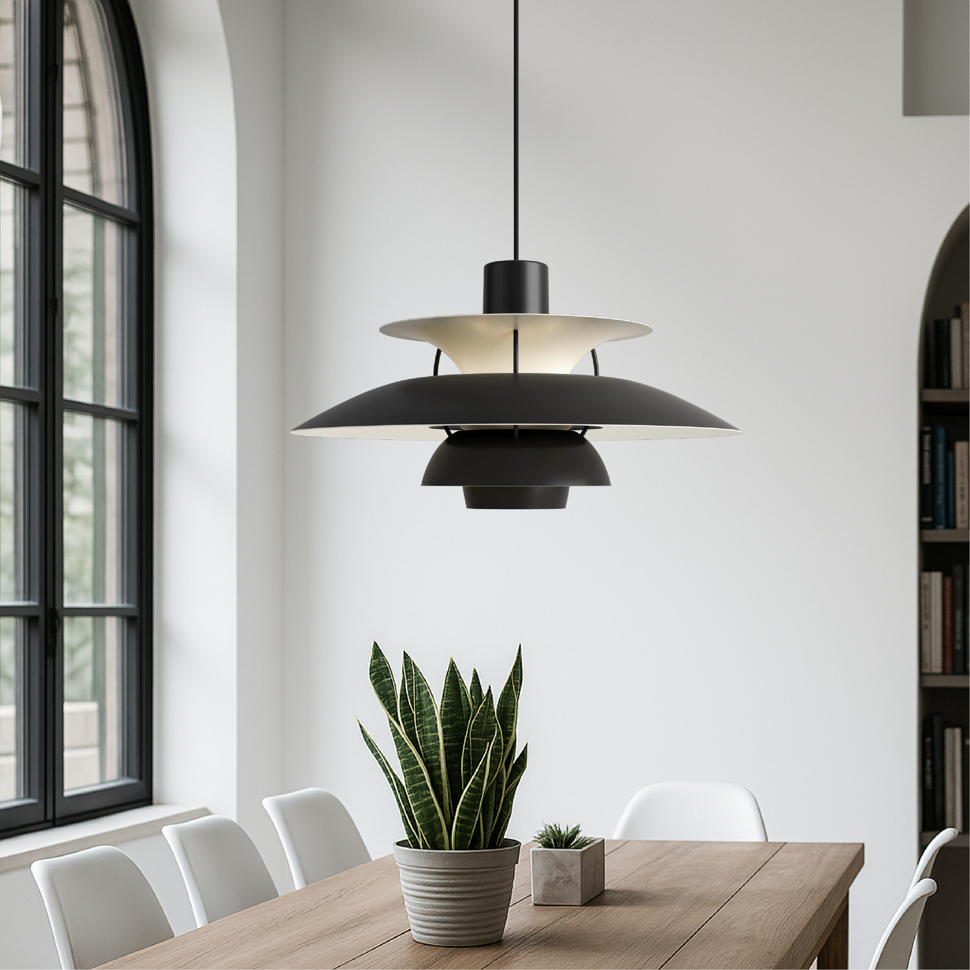 Black aluminum pendant light with layered metal shades in modern dining area