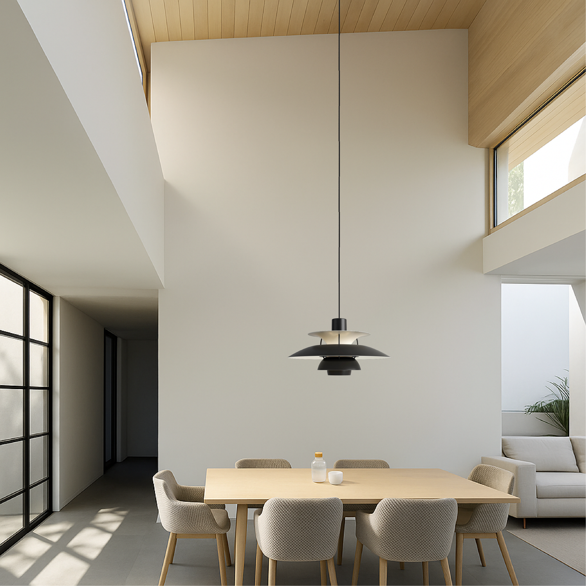 Black and white pendant light with small tiered shades, centered above dining table