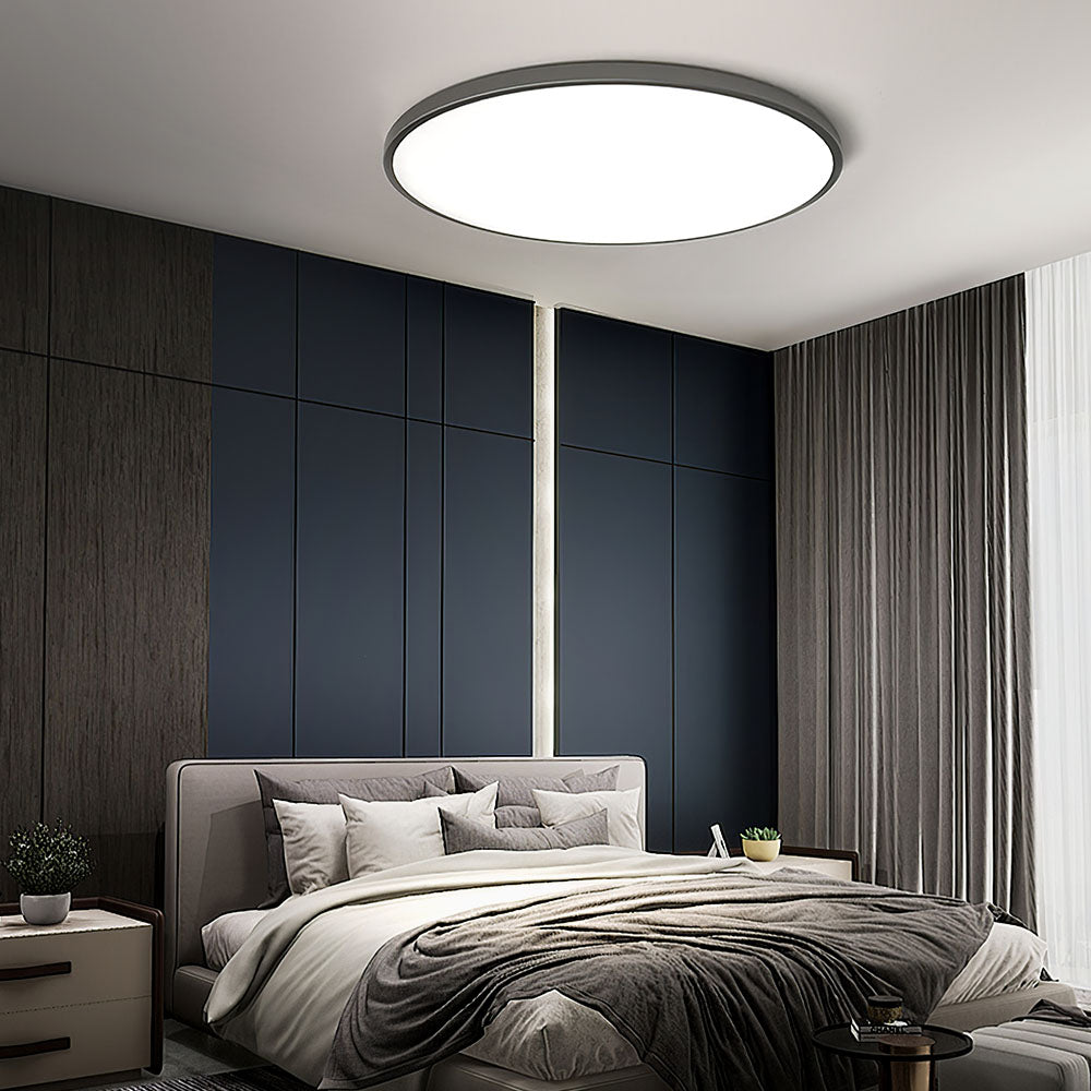 Round flat LED ceiling light with frosted acrylic diffuser and dark gray rim.