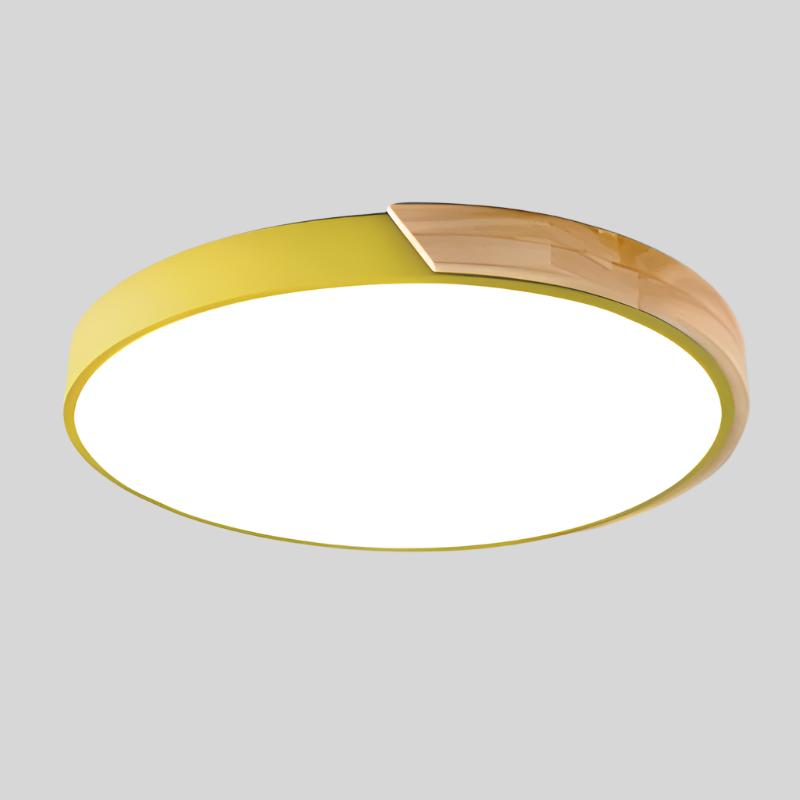 Round ceiling light with white acrylic diffuser and yellow metal rim, warm wood accent