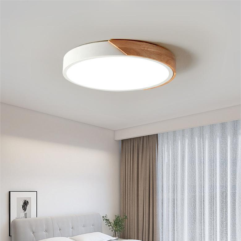 Round ceiling light with white acrylic diffuser and white metal rim, warm wood accent