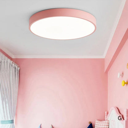 Round ceiling light with white acrylic diffuser and pink metal rim