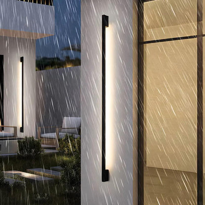 Slim dark LED wall light strip with white glow, shown mounted on an exterior wall