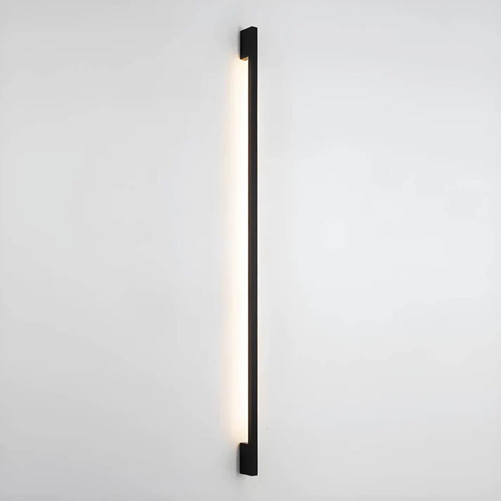 Single slim dark LED wall light strip, mounted flush and emitting a white linear glow