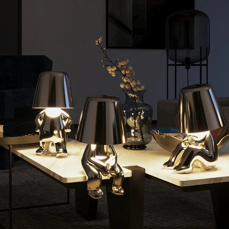 Gold LED figurine table lamps with metallic cone shades on light display table