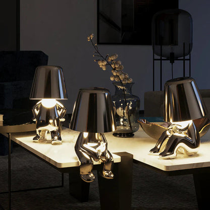 Gold LED figurine table lamps with metallic cone shades on light display table