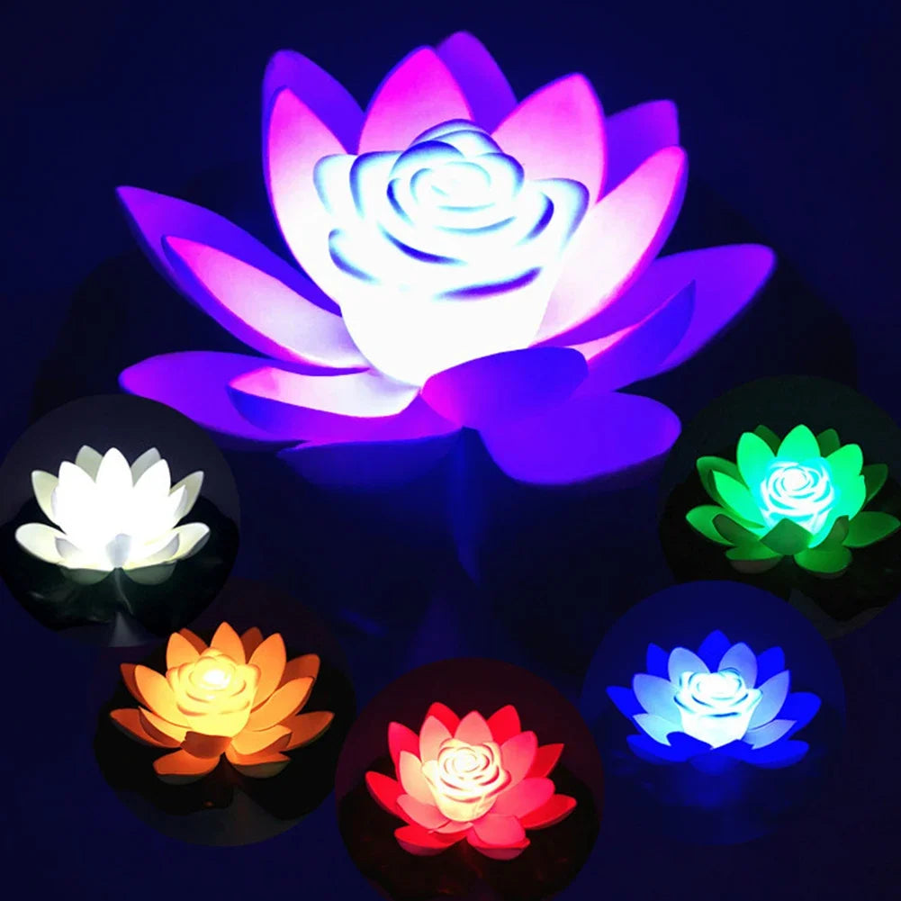 Set of glowing floating lotus LED pond lights in multiple colors on dark background