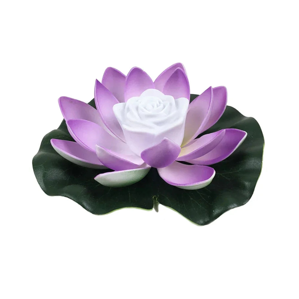 Floating lotus LED pond light with purple petals, white center, and dark green leaves