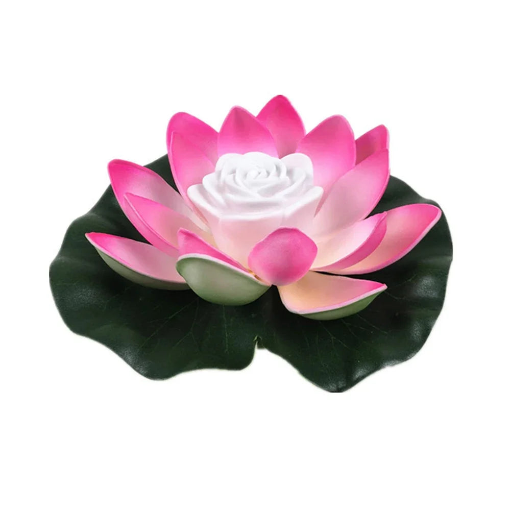 Floating lotus LED pond light with bright pink petals, white center, and dark green leaves