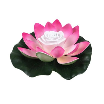 Floating lotus LED pond light with bright pink petals, white center, and dark green leaves