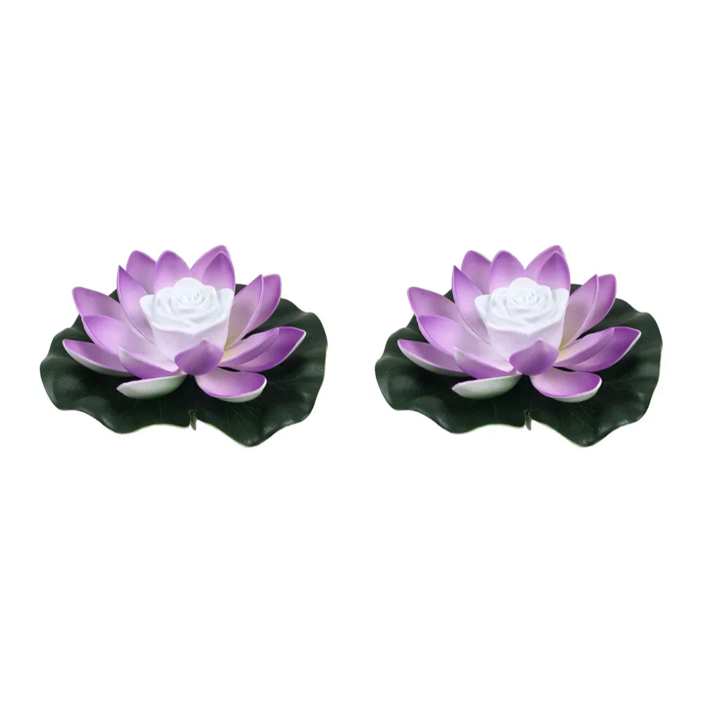 Pair of purple floating lotus pond lights with white center roses and dark leaves