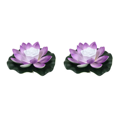 Pair of purple floating lotus pond lights with white center roses and dark leaves