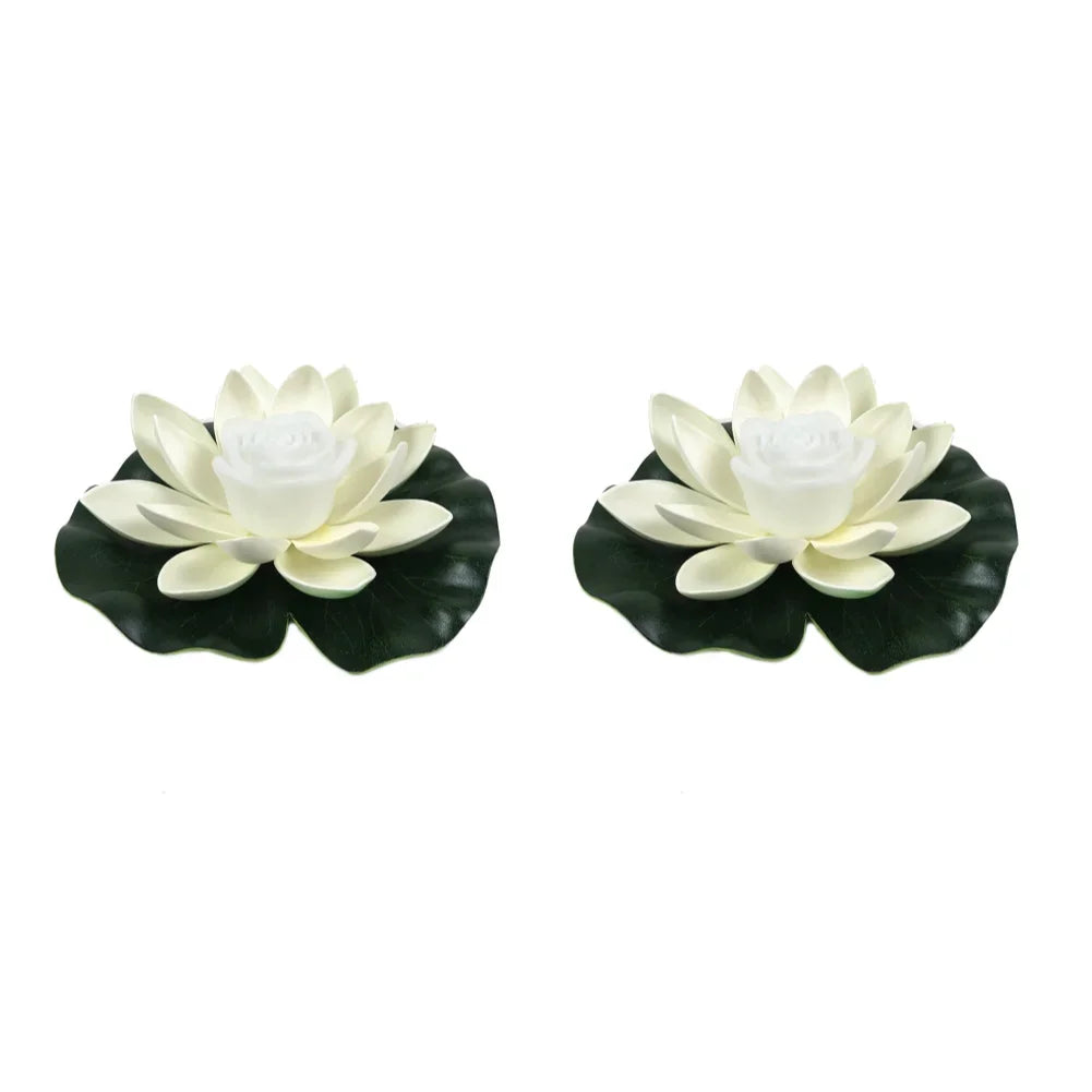 Pair of white floating lotus pond lights with white center roses and dark green leaves