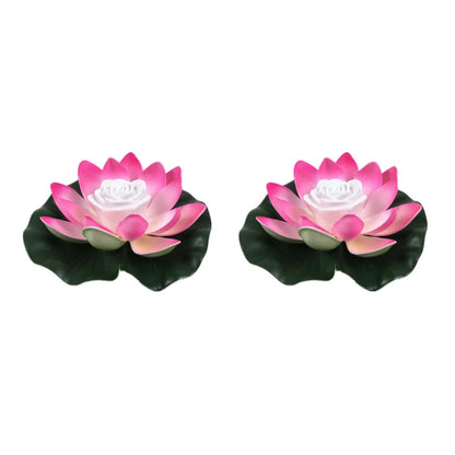 Pair of floating lotus LED pond lights with pink petals, white center, and dark green leaves
