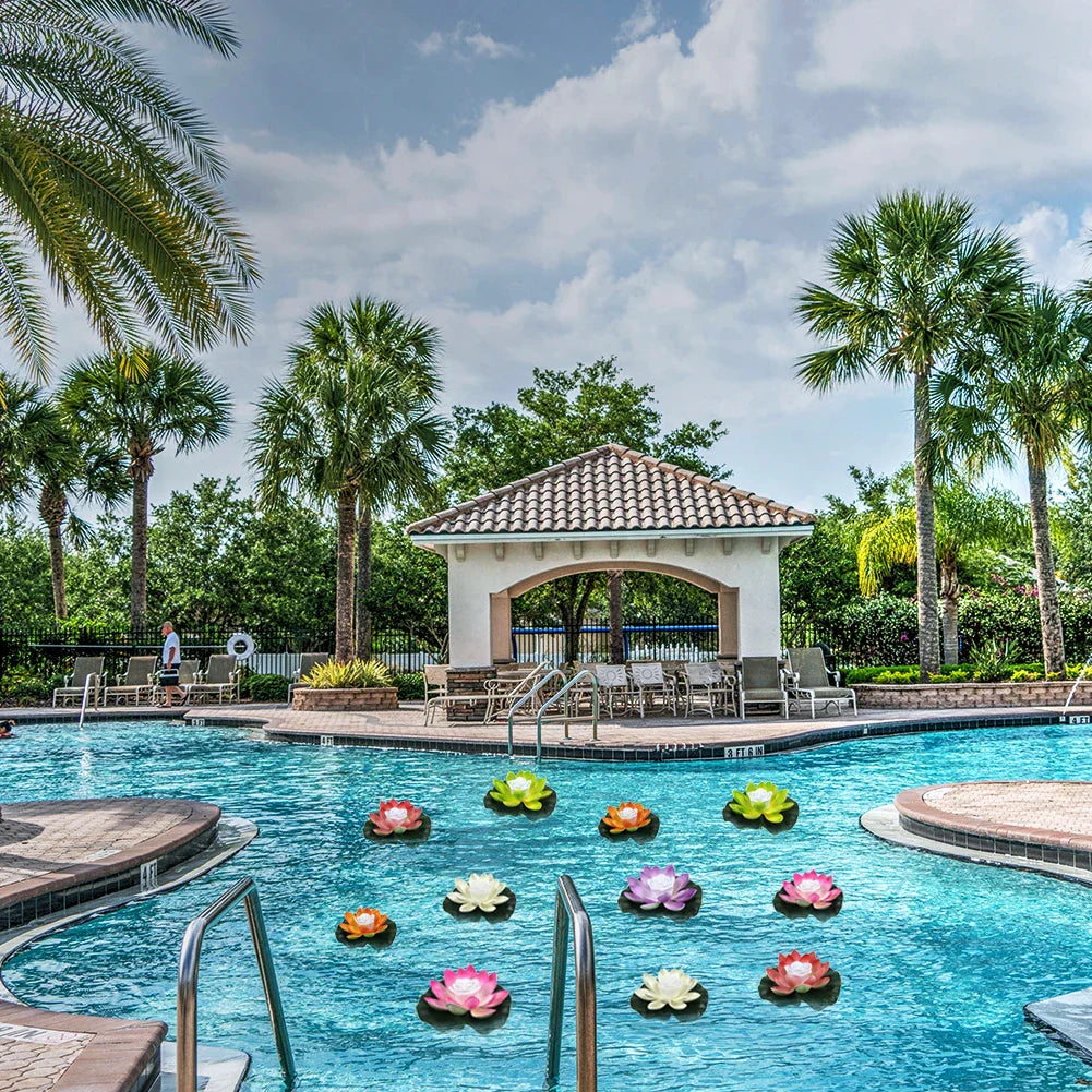 Colorful floating lotus pond lights scattered across a swimming pool water surface