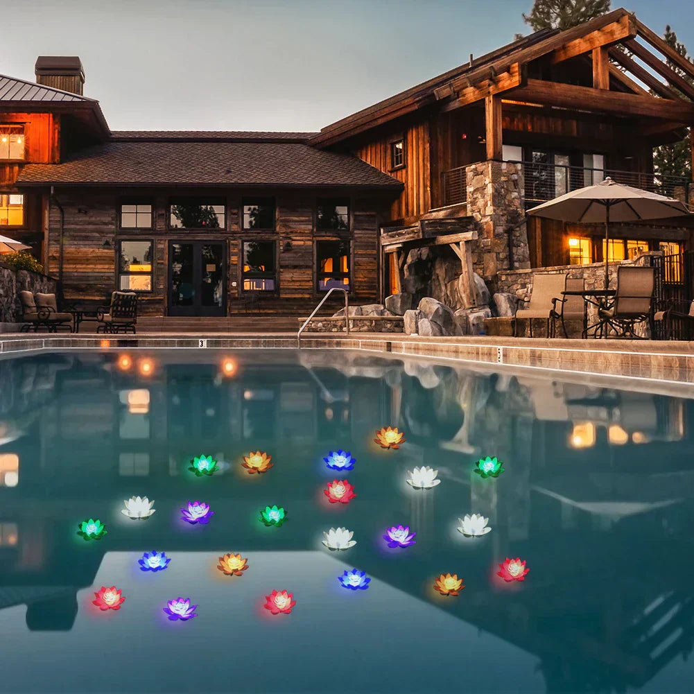 Set of glowing floating lotus pond lights in multiple colors across pool water