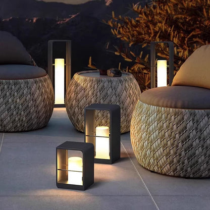 Modern black metal LED outdoor lantern light, warm glowing cube housing