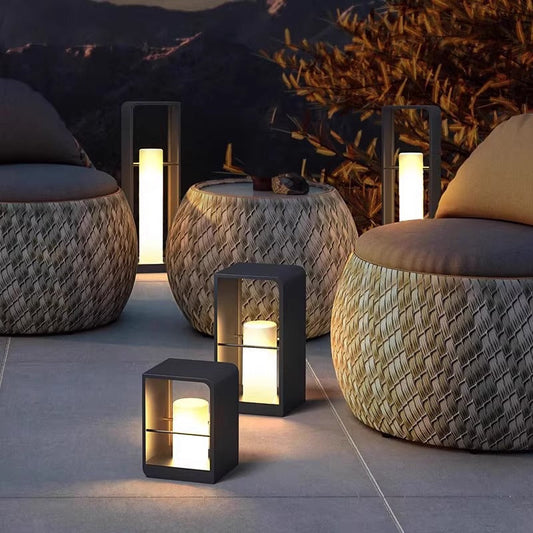 Modern black metal LED outdoor lantern light, warm glowing cube housing