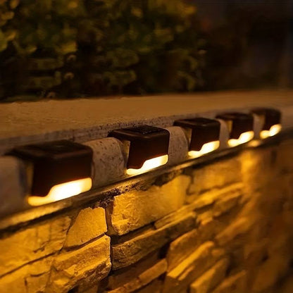 Solar LED outdoor wall lights mounted on stone wall with warm glow between stones