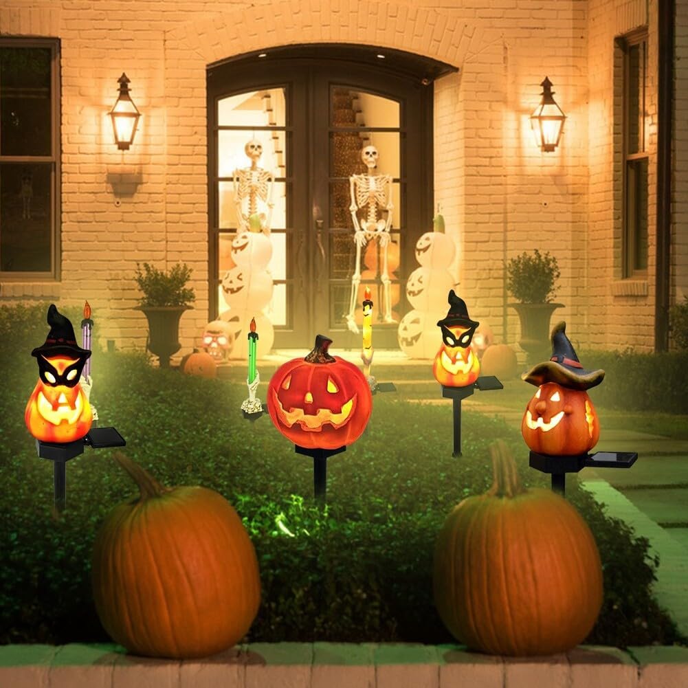 Glowing jack-o-lantern solar garden lights on black stakes, Halloween yard display