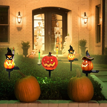 Glowing jack-o-lantern solar garden lights on black stakes, Halloween yard display