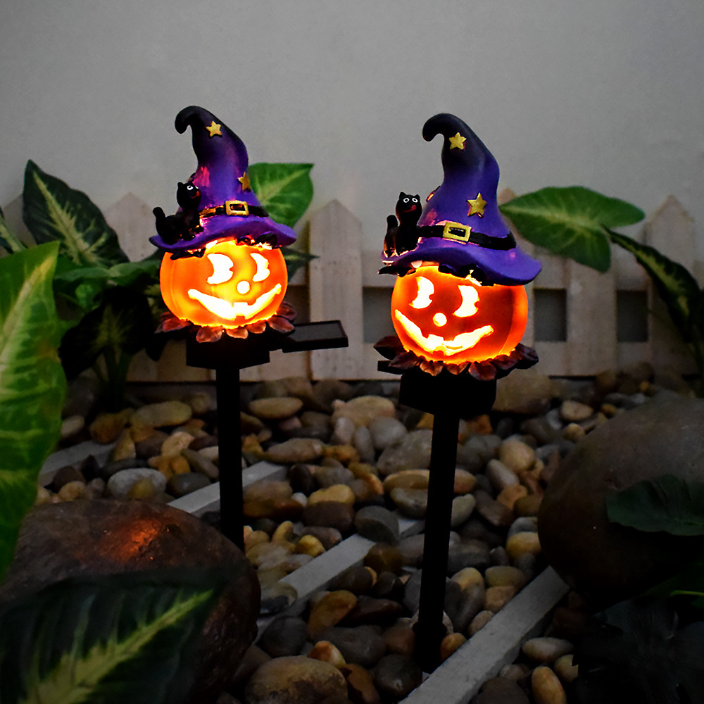 Solar Halloween garden light pair: glowing orange jack-o'-lanterns in purple witch hats