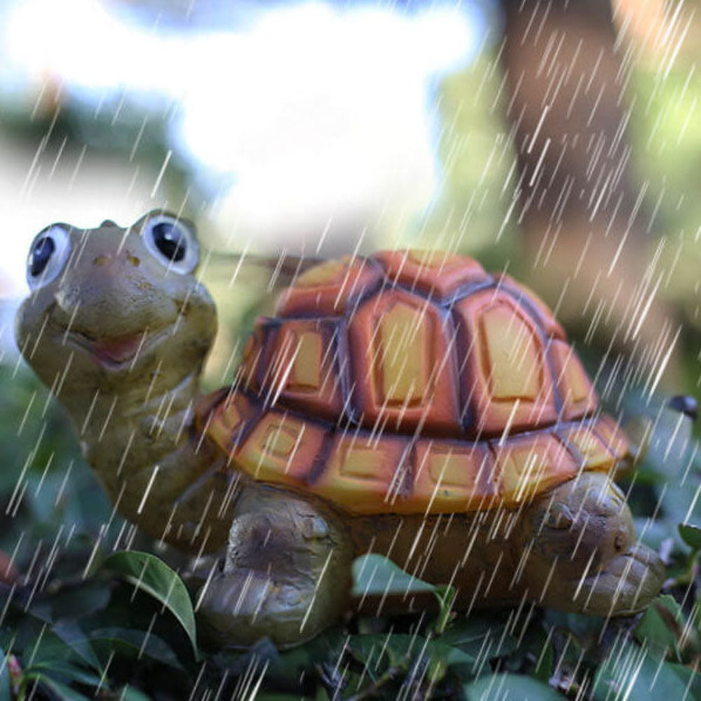 Solar turtle garden light figure, rain-speckled, in brown resin with glowing LED