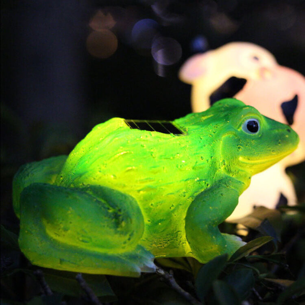 Solar frog garden light figure in bright green resin, LED glow on garden leaves