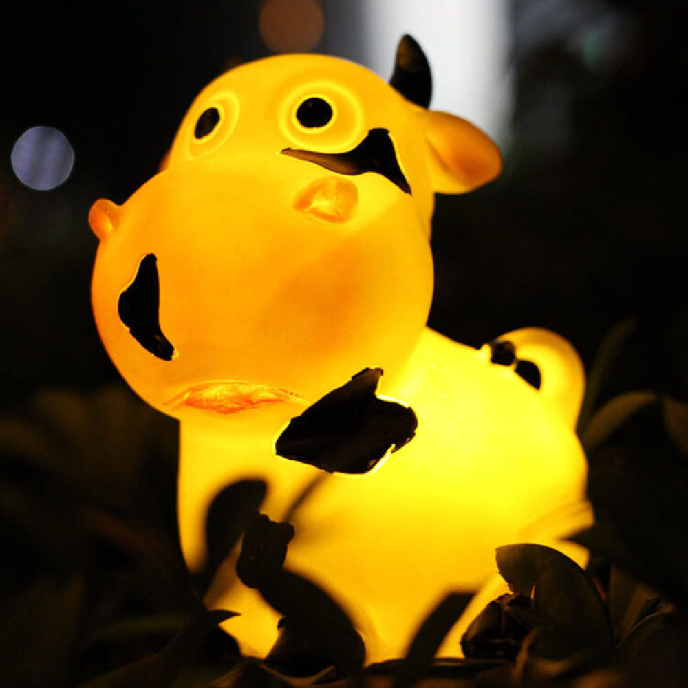 Solar animal garden light figure shaped as a glowing deer, resin, sitting on grass