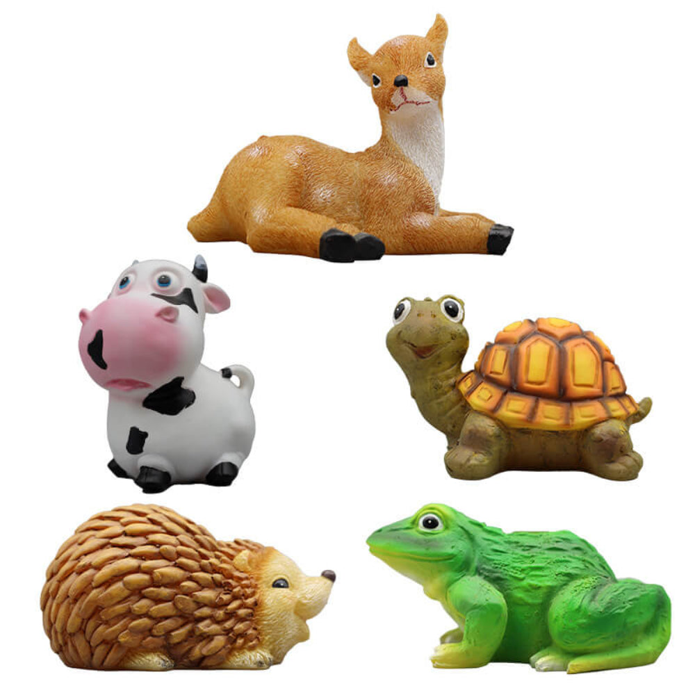 Solar animal garden light figures on display: deer, cow, turtle, frog, and hedgehog