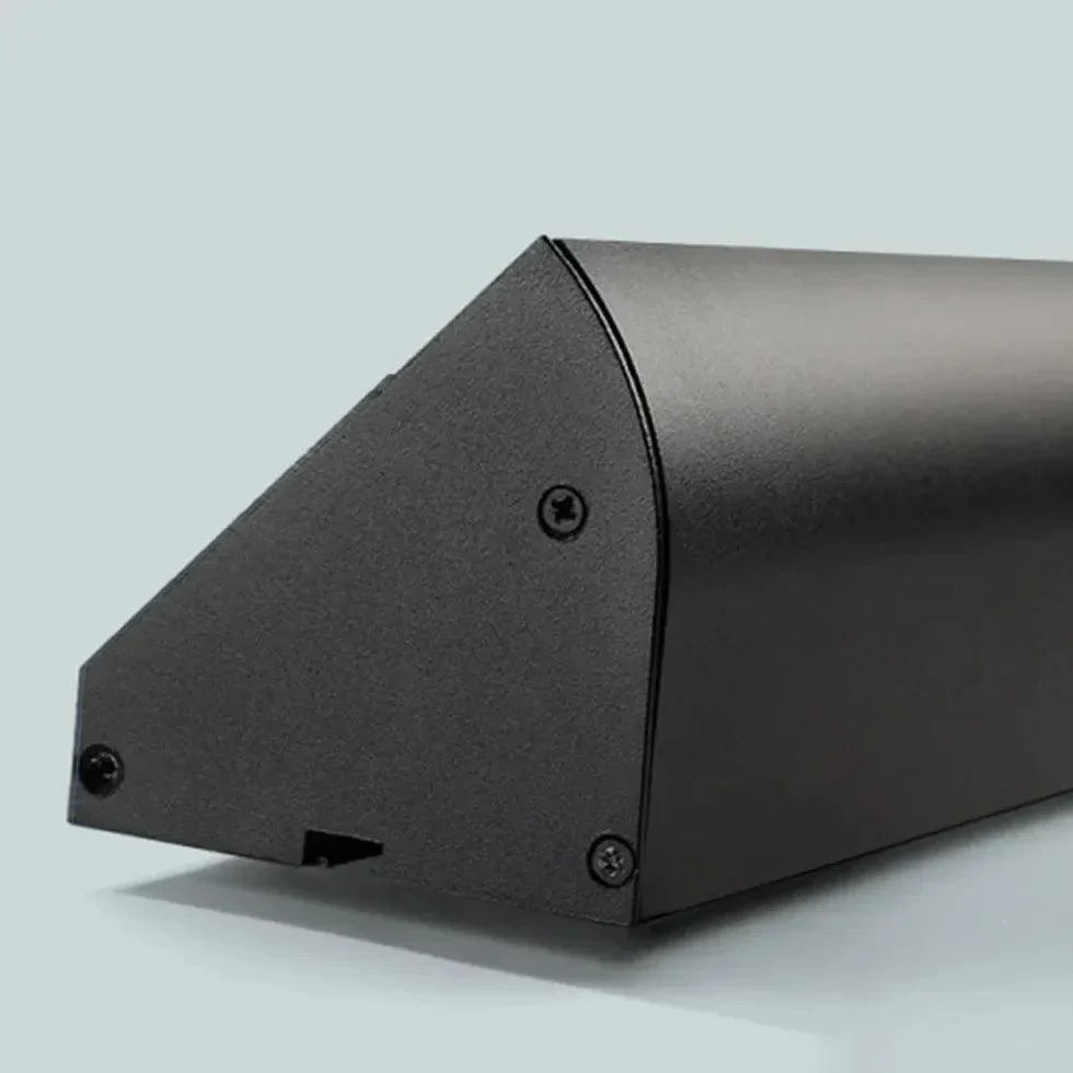 Black linear LED outdoor light end section with screw fasteners and corner edge