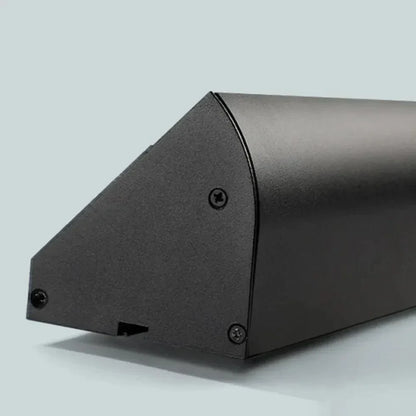 Black linear LED outdoor light end section with screw fasteners and corner edge
