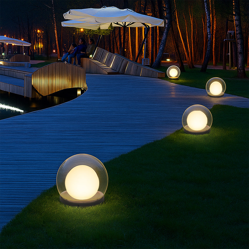 Outdoor LED ball garden lamps with glowing clear globes along a walkway and lawn