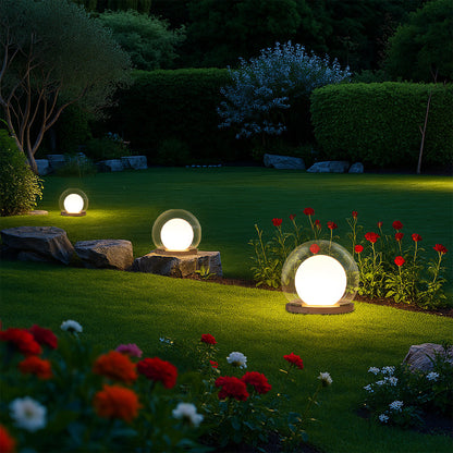 Outdoor LED globe ball lights on stone bases, warm white glow